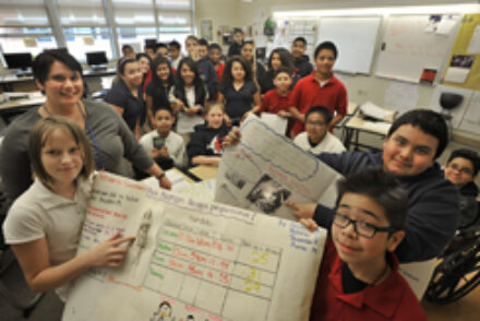 Tacoma Public School 7th. grade teacher Jennifer Crump at First Creek Middle School in Tacoma, WA. had her students do a body mass project.   Photo I.D. left to right Teacher:  Jennifer Crump , students holding posters, foreground female student Oksana Bo
