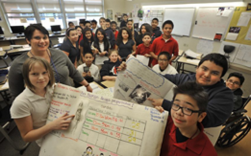 Tacoma Public School 7th. grade teacher Jennifer Crump at First Creek Middle School in Tacoma, WA. had her students do a body mass project.   Photo I.D. left to right Teacher:  Jennifer Crump , students holding posters, foreground female student Oksana Bo